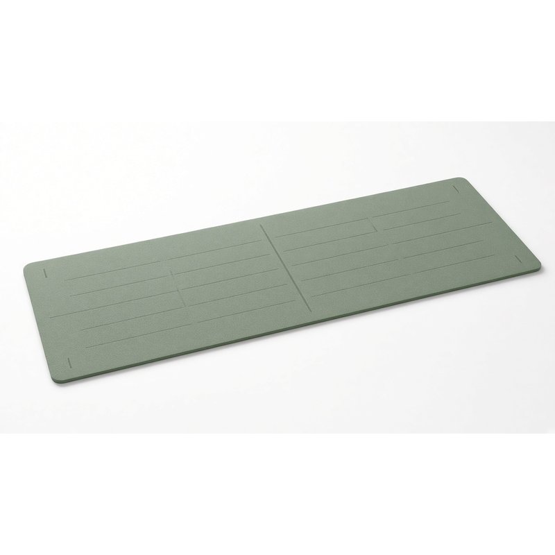 Yoga mat with subtle printed alignment lines, on a white background